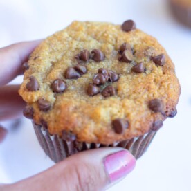 Healthy Banana muffin topped with chocolate chips in hand