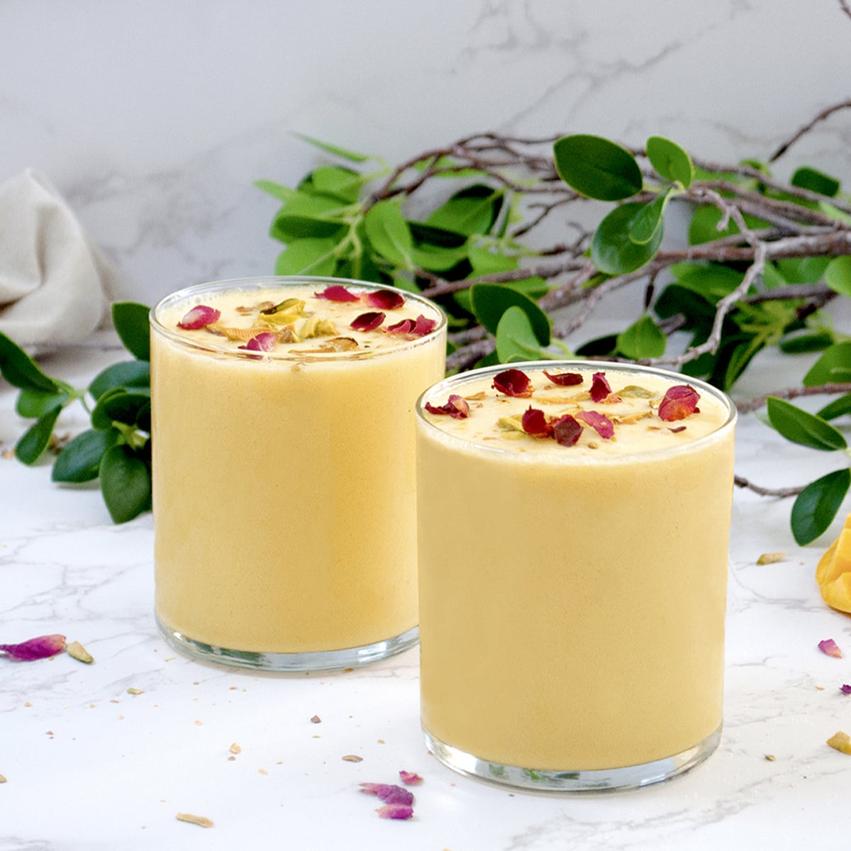 Mango milkshake garnished with rose petals