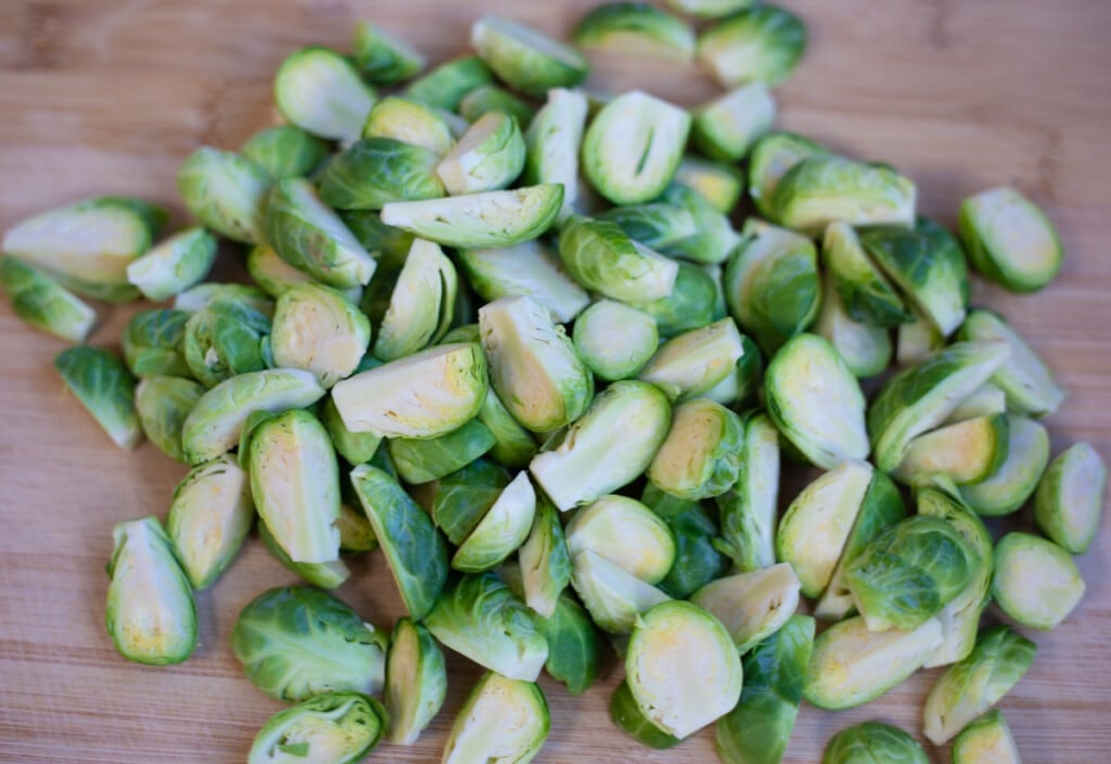 Quartered or halved Brussels sprouts on a cutting board