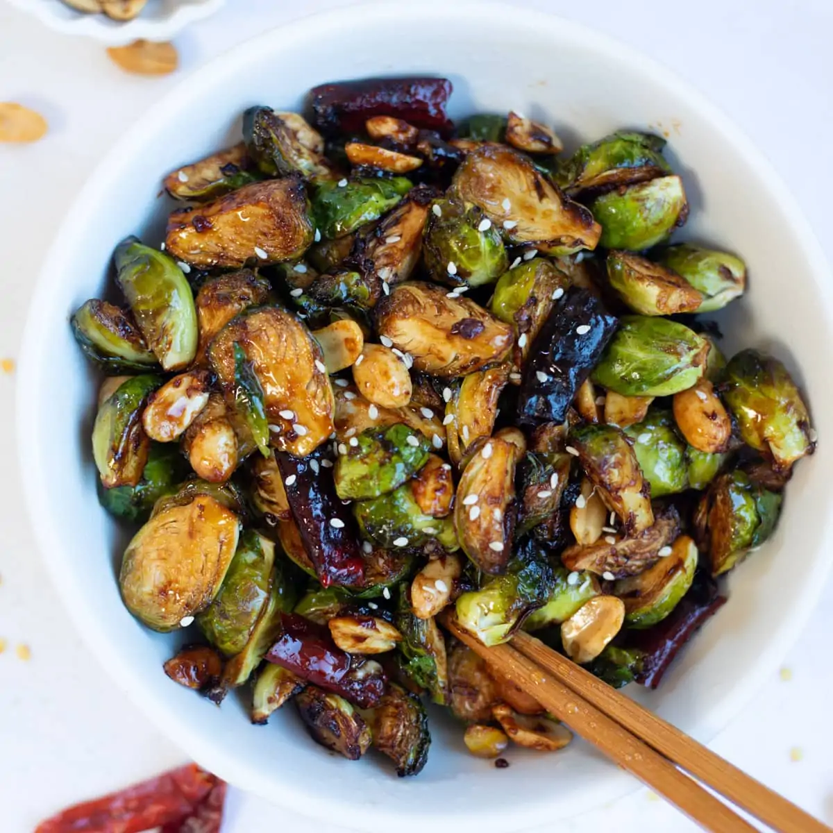 Asian style kung pan Brussels sprouts in a bowl with chopsticks