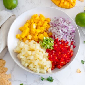 Mix all the ingredients in a bowl for pineapple mango salsa
