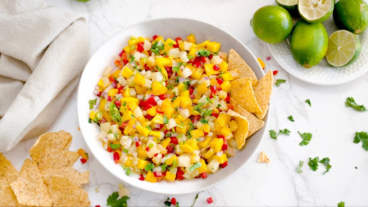 pineapple mango salsa in a bowl with tortilla chips