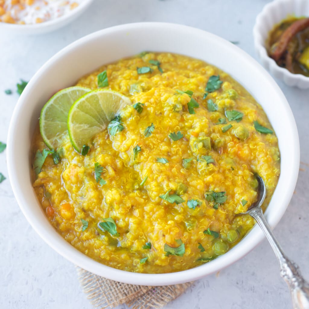 Quinoa Khichdi in a bowl topped with cilantro