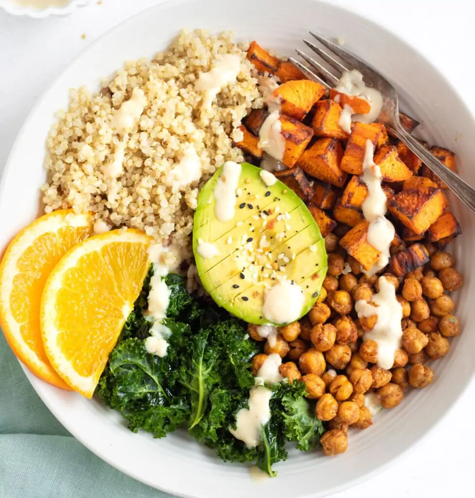 Vegan Sweet Potato Chickpea Quinoa Buddha Bowl topped with avocado