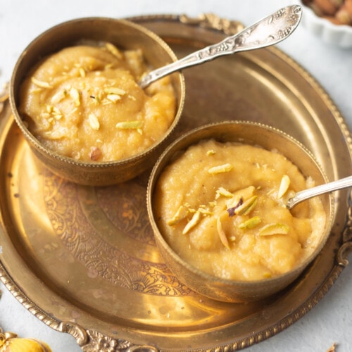Besan ka Halwa garnished with pistachios in 2 bowls