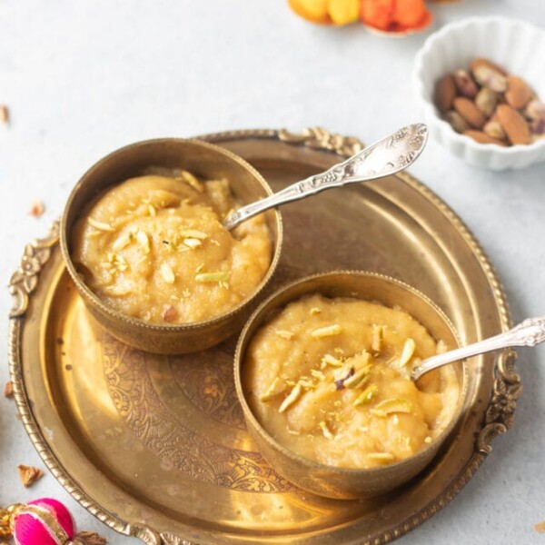 Besan Halwa served in 2 bowls garnished with nuts