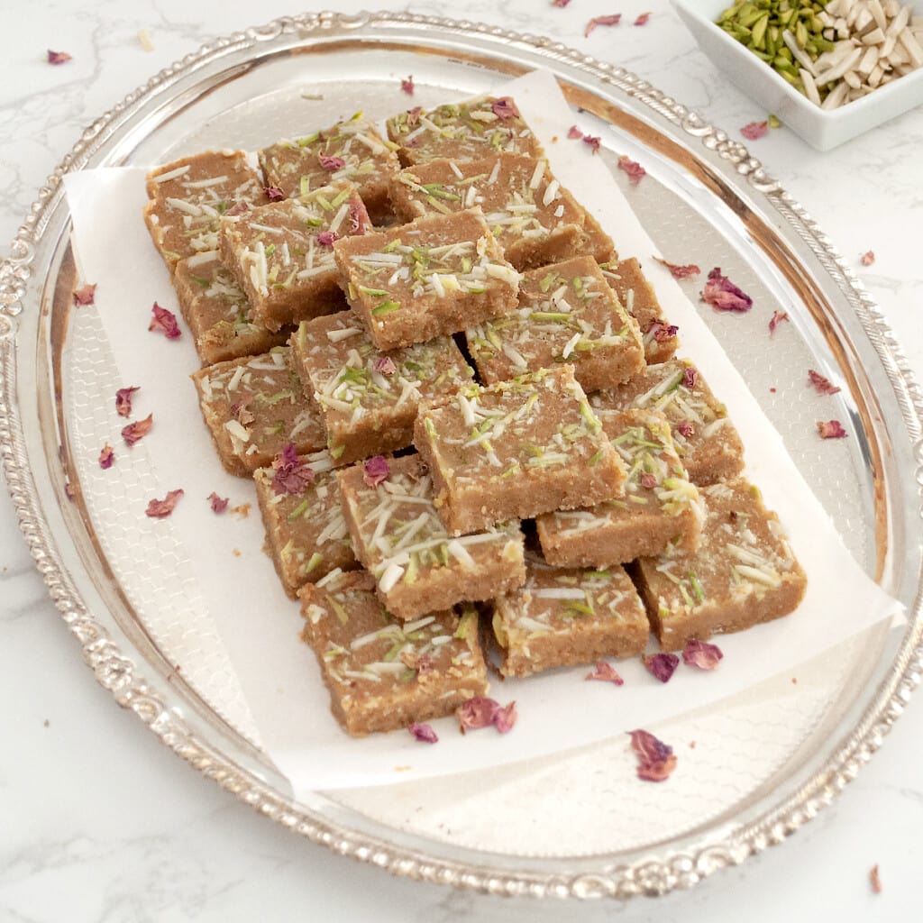 traditional Gujarati magas sweet in a serving tray garnished with rose petals