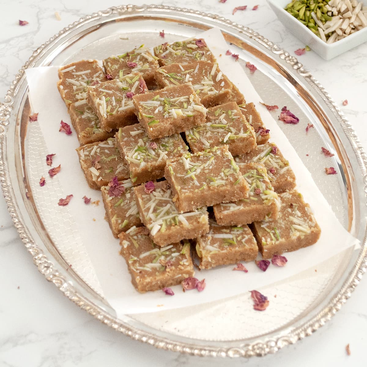 traditional Gujarati magas sweet in a serving tray garnished with rose petals 
