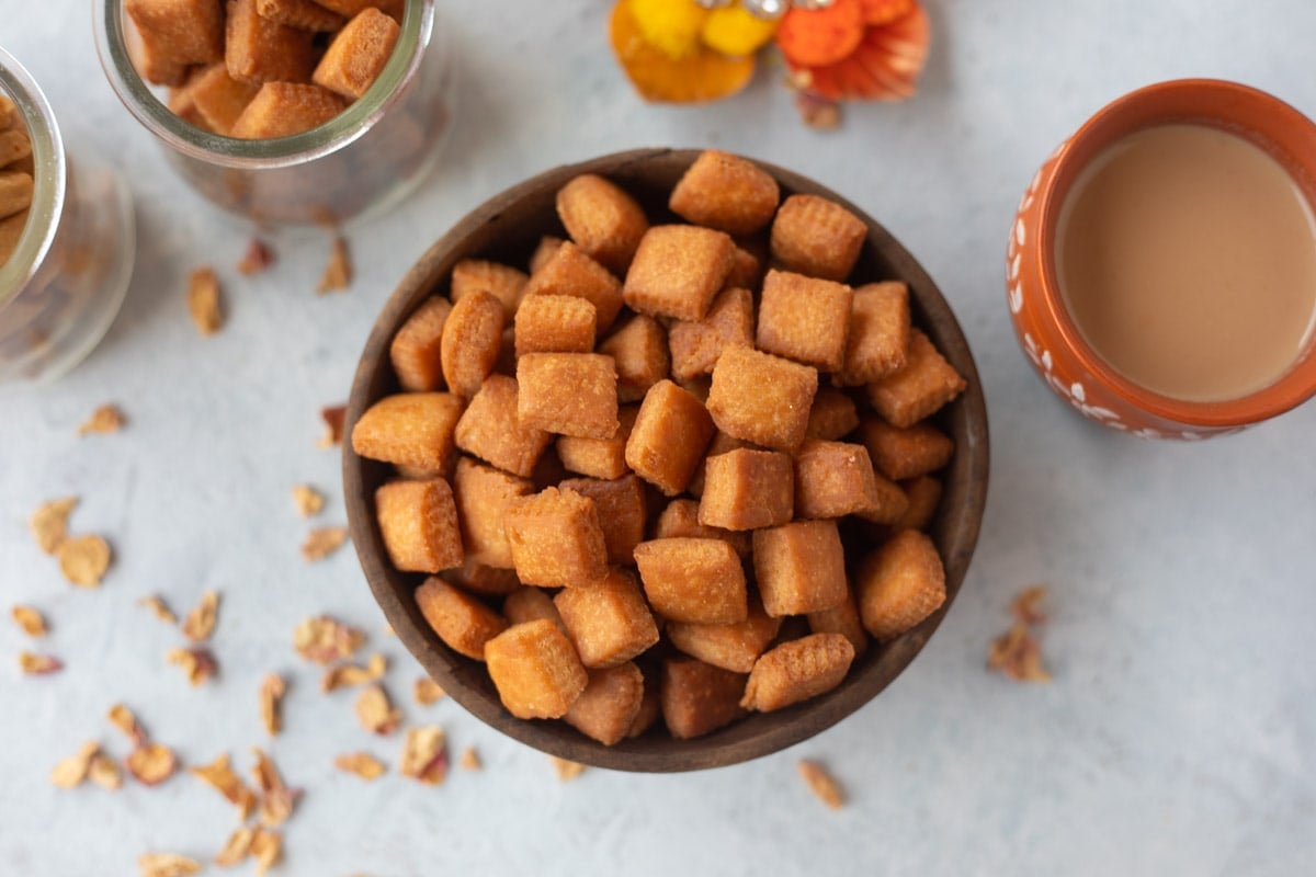 Shakarpara served in a bowl with chai for Diwali snacks 