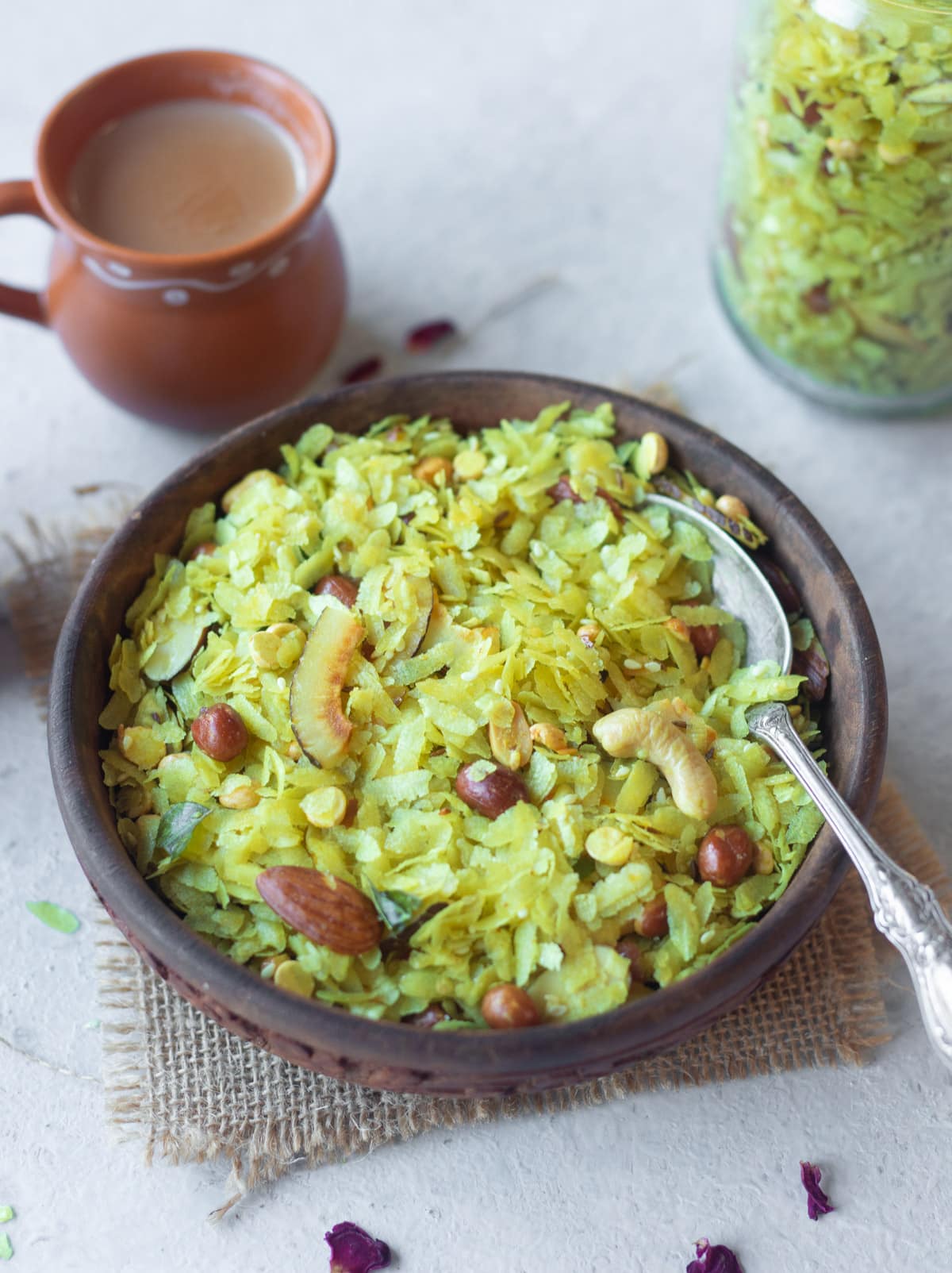 roasted poha chivda in a bowl served with tea as a snack
