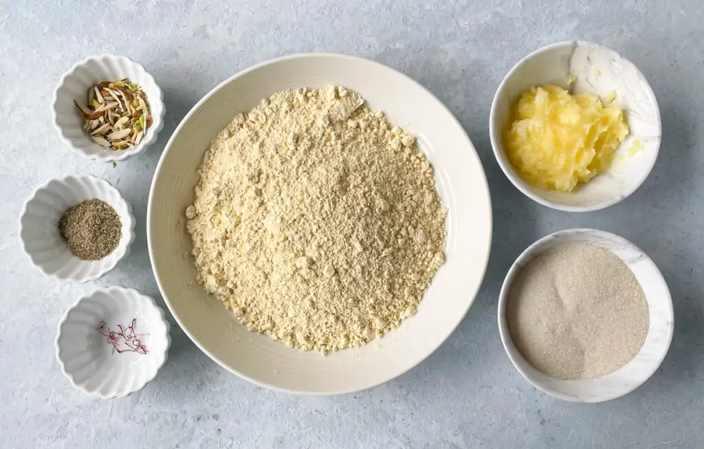 Ingredients for besan Burfi - gram flour, sugar, ghee, cardamom, nuts and saffron