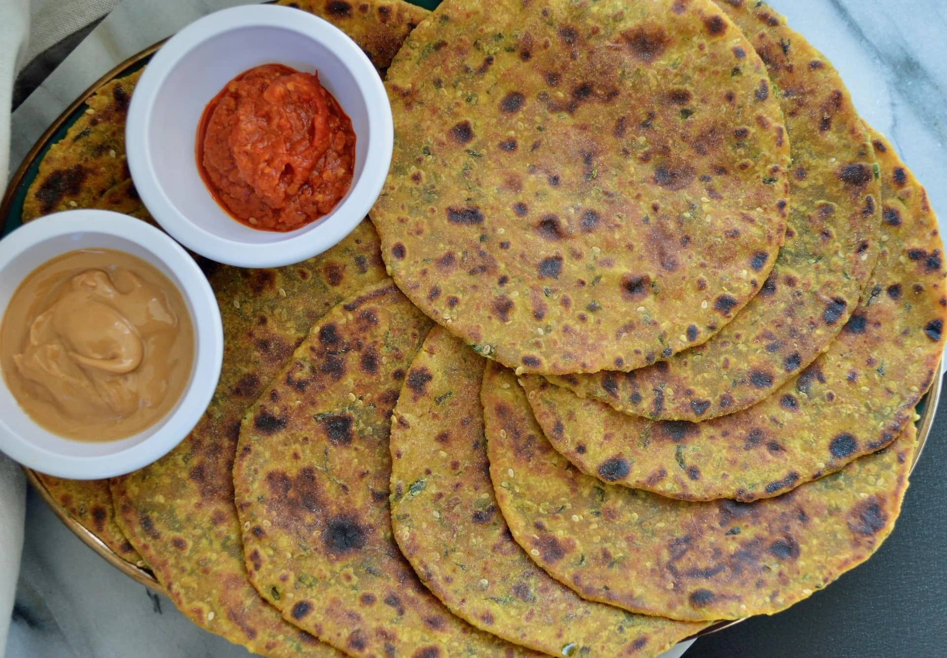 Thepla in a plate with chutneys