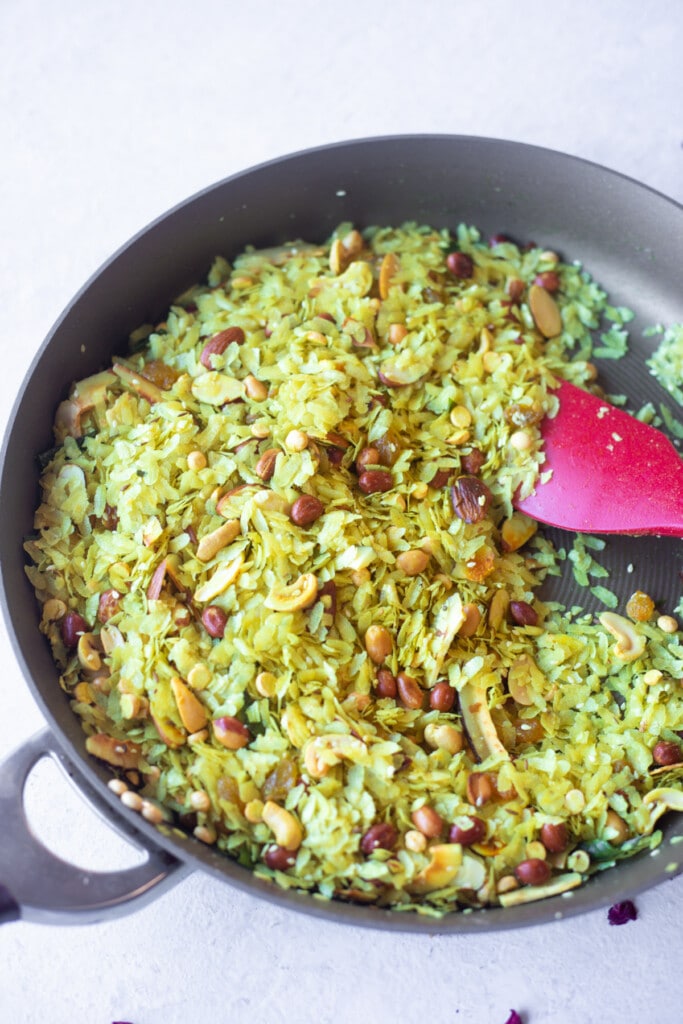 Healthy Roasted poha chivda in a pan with lots of peanuts, cashews and almonds 