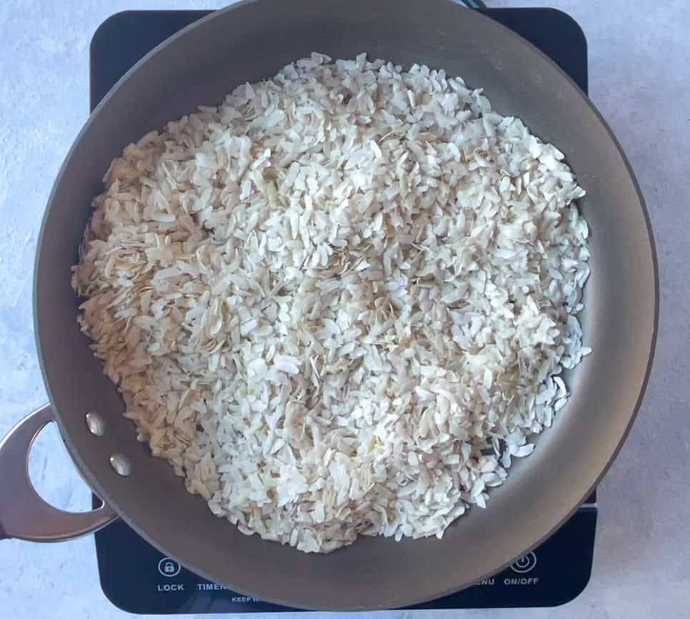 roasting poha in a pan on stovetop 