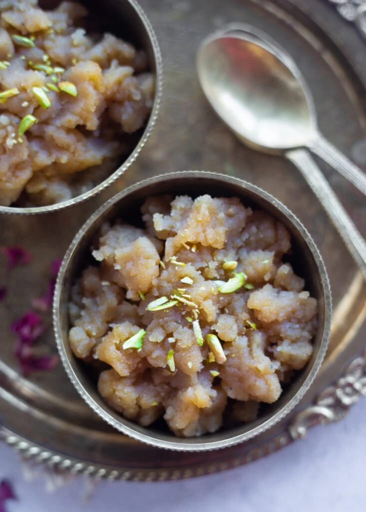 Kada Prasad (also called data halwa) served in bowls garnished with pistachios 