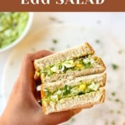 avocado egg salad sandwich in hand