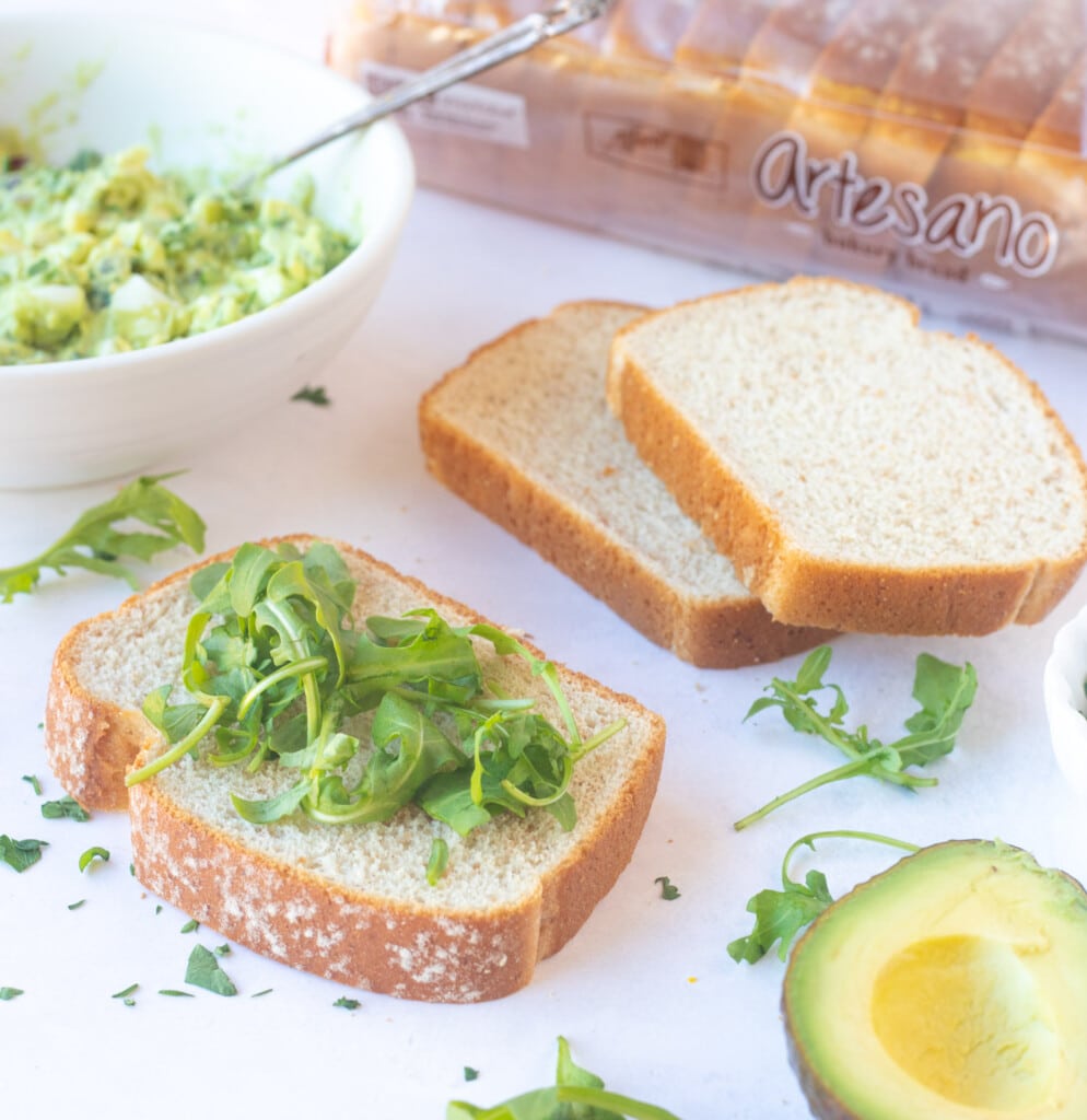 Top the bread with some greens such as spinach or arugula