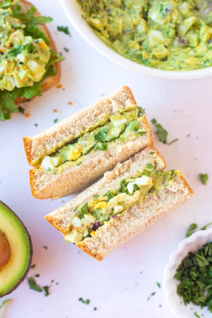 Avocado and Egg salad sandwich on a table 