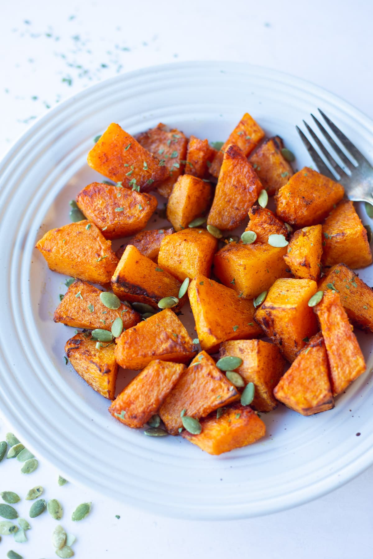 Air Fryer Pumpkin in a plate garnished with pumpkin seeds 