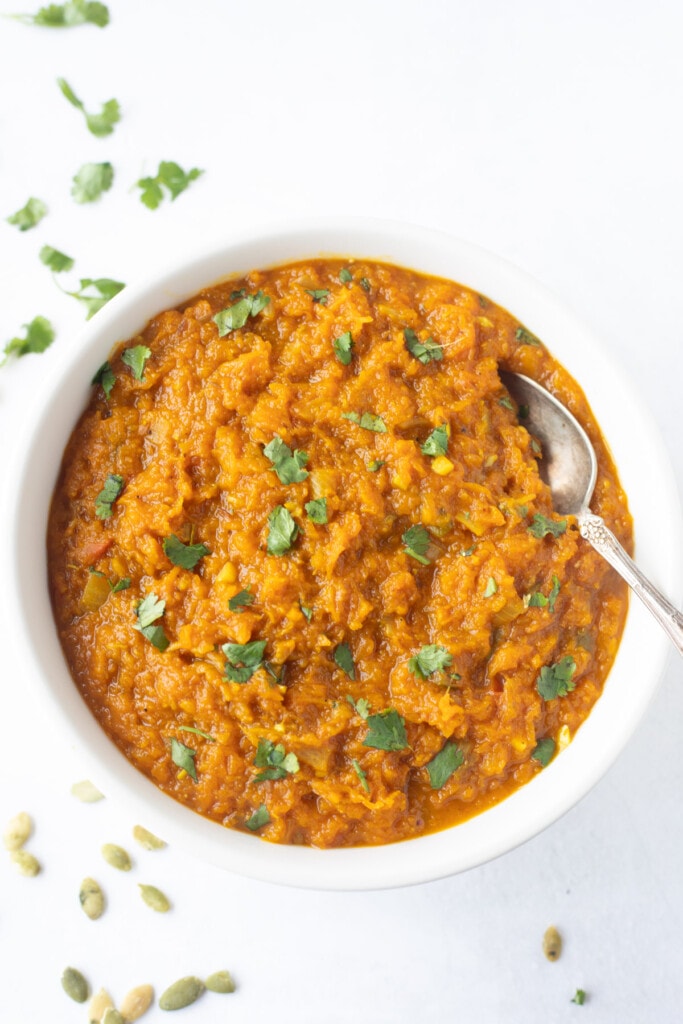 indian pumpkin curry garnished with cilantro in a bowl 