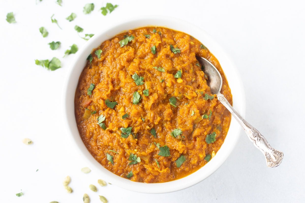 indian pumpkin curry (kaddu ki subzi) garnished with cilantro in a bowl