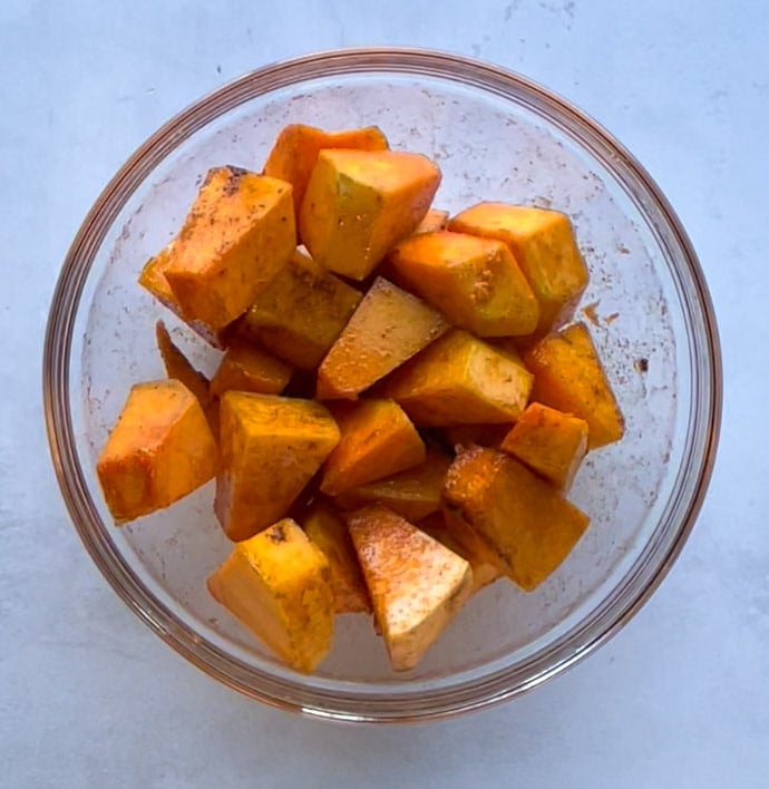 seasoned pumpkin cubes in a bowl 