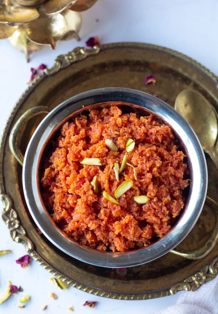 Gajar ka halwa (indian carrot pudding) in a pretty bowl topped with pistachios