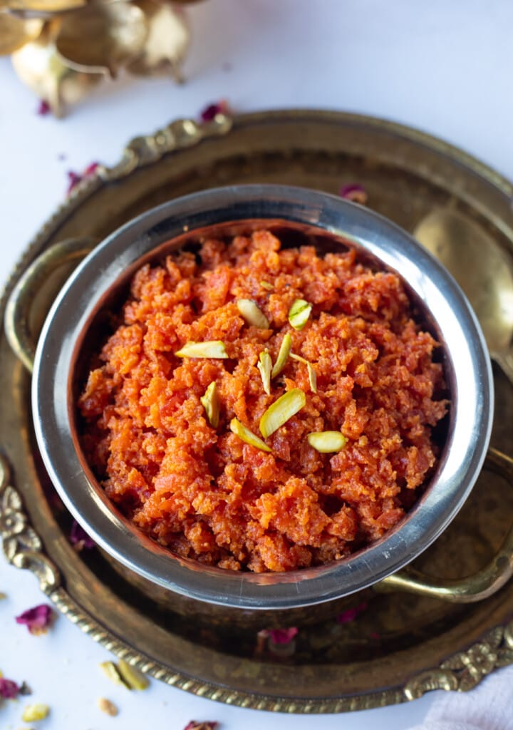 Carrot halwa in a bowl garnished with nuts 