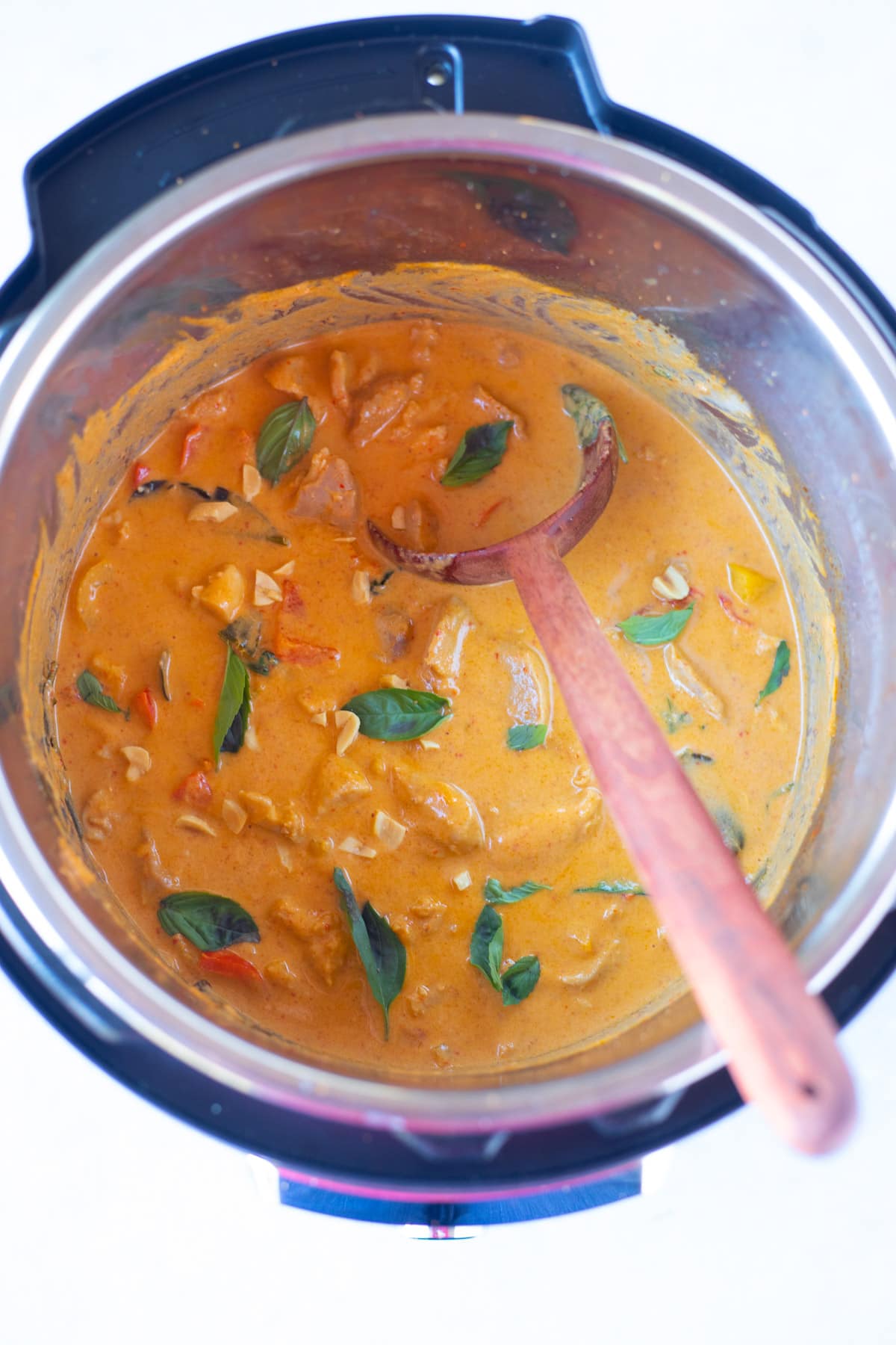 instant pot Panang Curry chicken garnished with thai basil leaves 