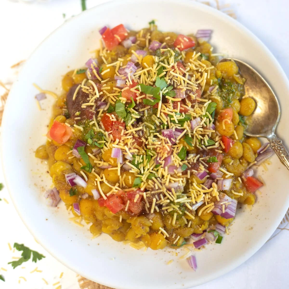 Ragda Chaat served in a white plate topped with sev