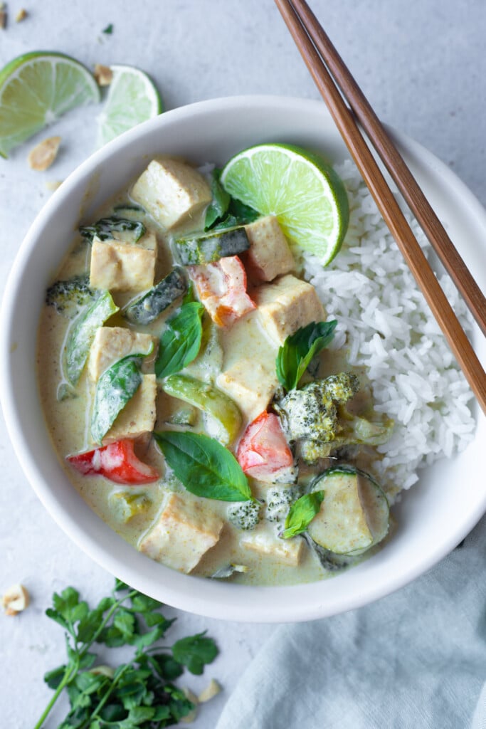 Thai Green Curry made in the instant pot served with jasmine rice in a white bowl 