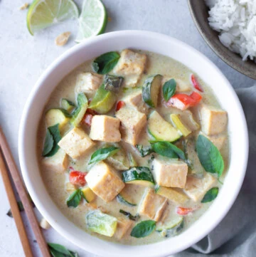 Thai Green Curry Tofu & Vegetables in a bowl with a side of rice.