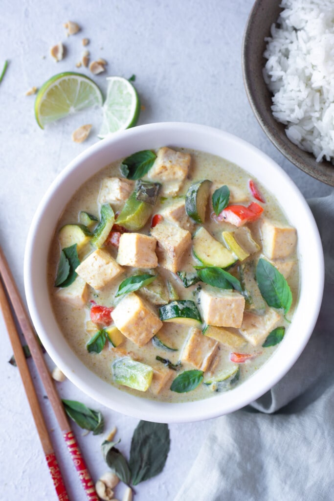 Thai Green Curry Tofu & Vegetables in a bowl with a side of rice.