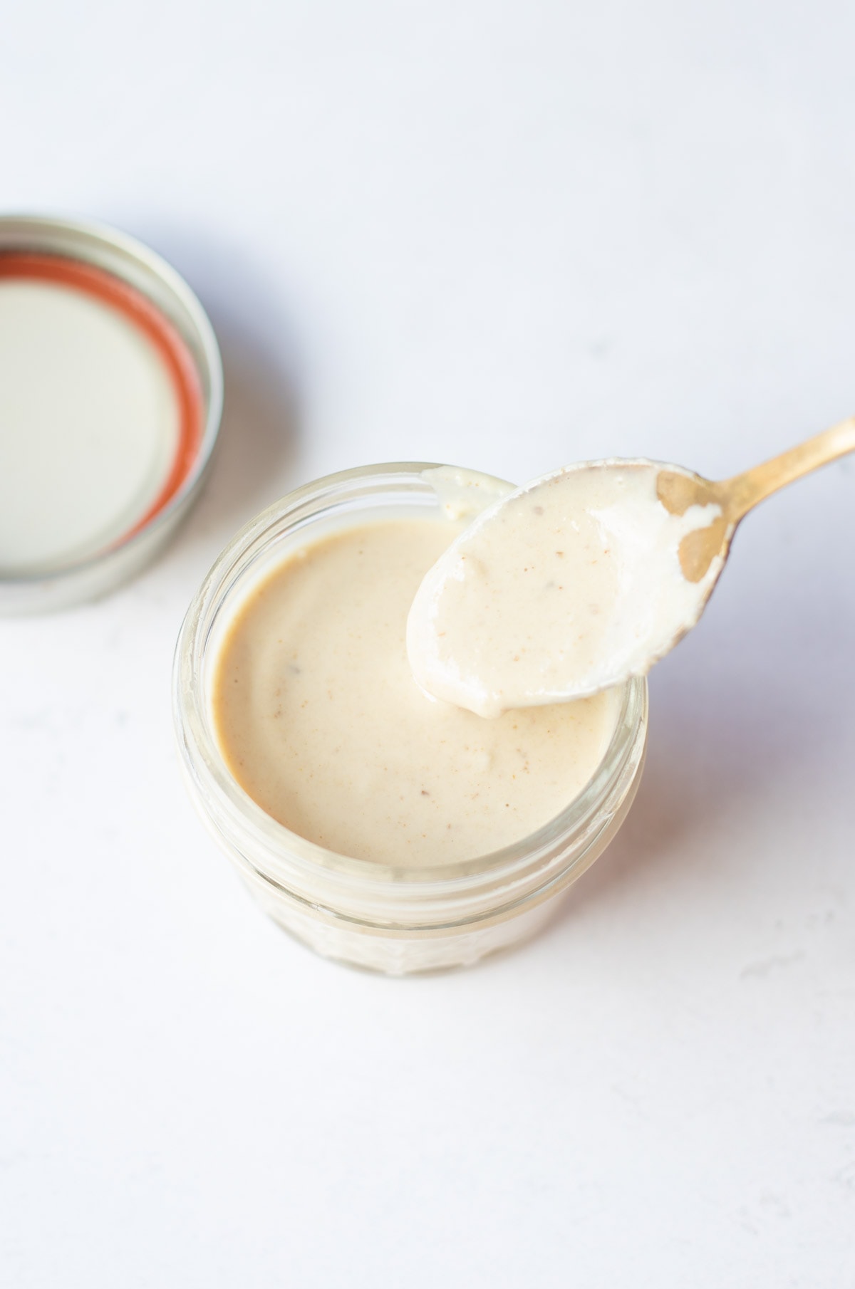 lemon tahini dressing in a small airtight container 