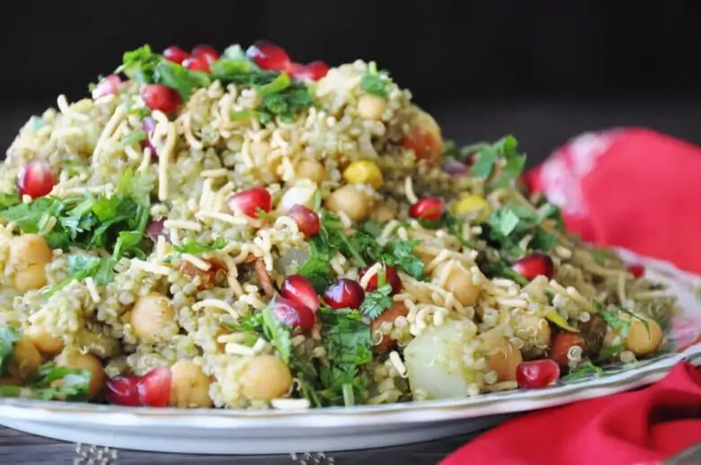 Quinoa bhel in a plate garnished with pomegranate seeds 