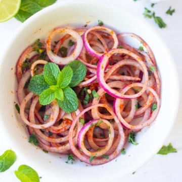 easy indian onion salad garnished with mint and spices