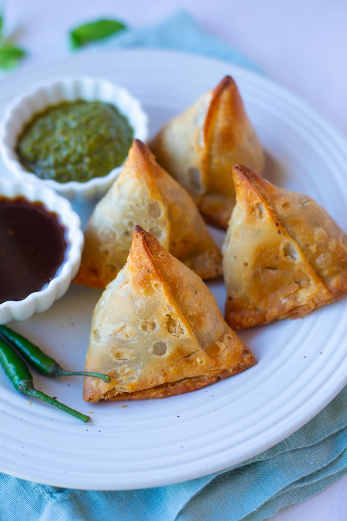 Air Fried Frozen Samosa in a plate served with chutneys