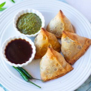 Air Fried Frozen Samosa in a plate served with chutneys