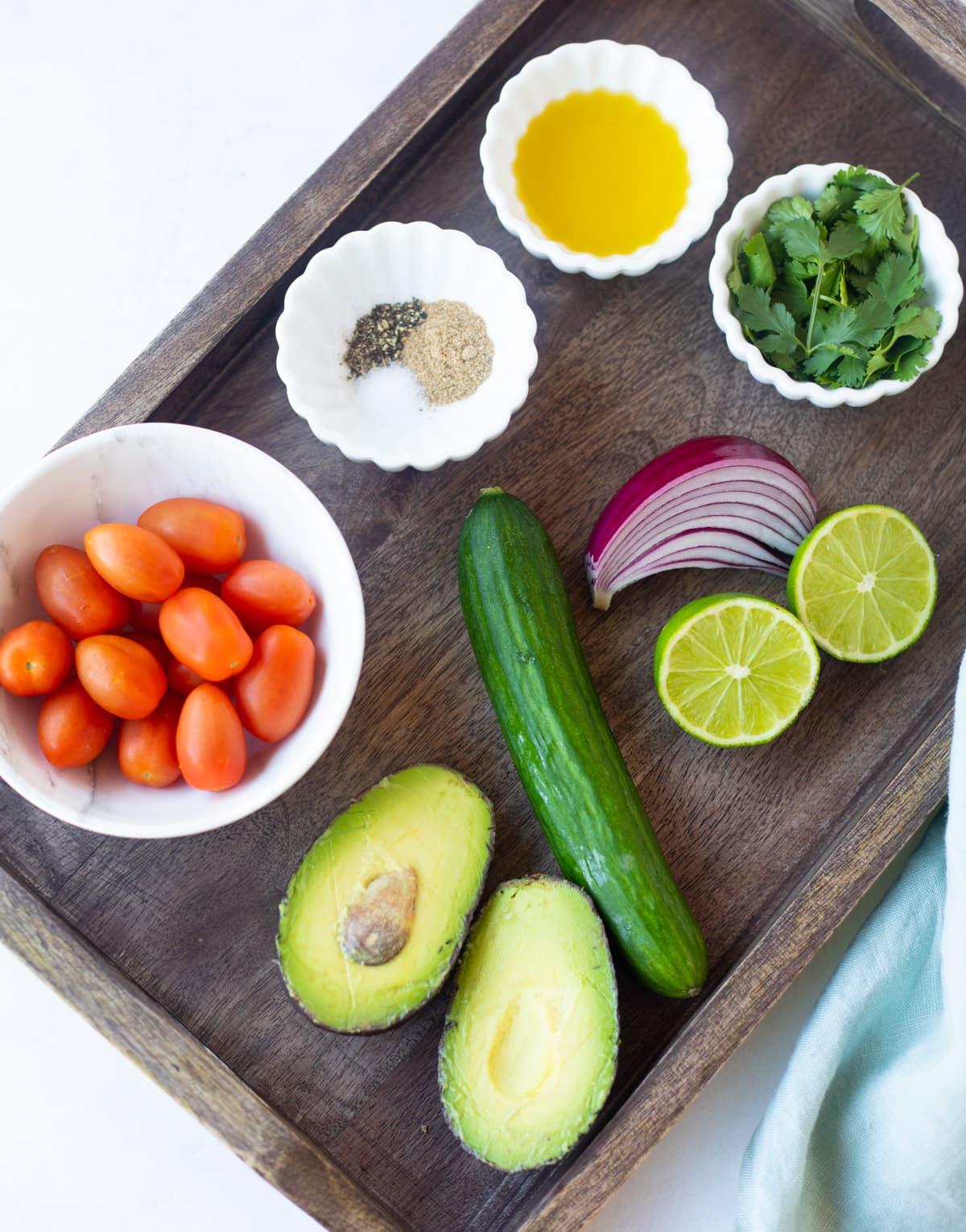 Ingredients to make avocado cucumber tomato salad 