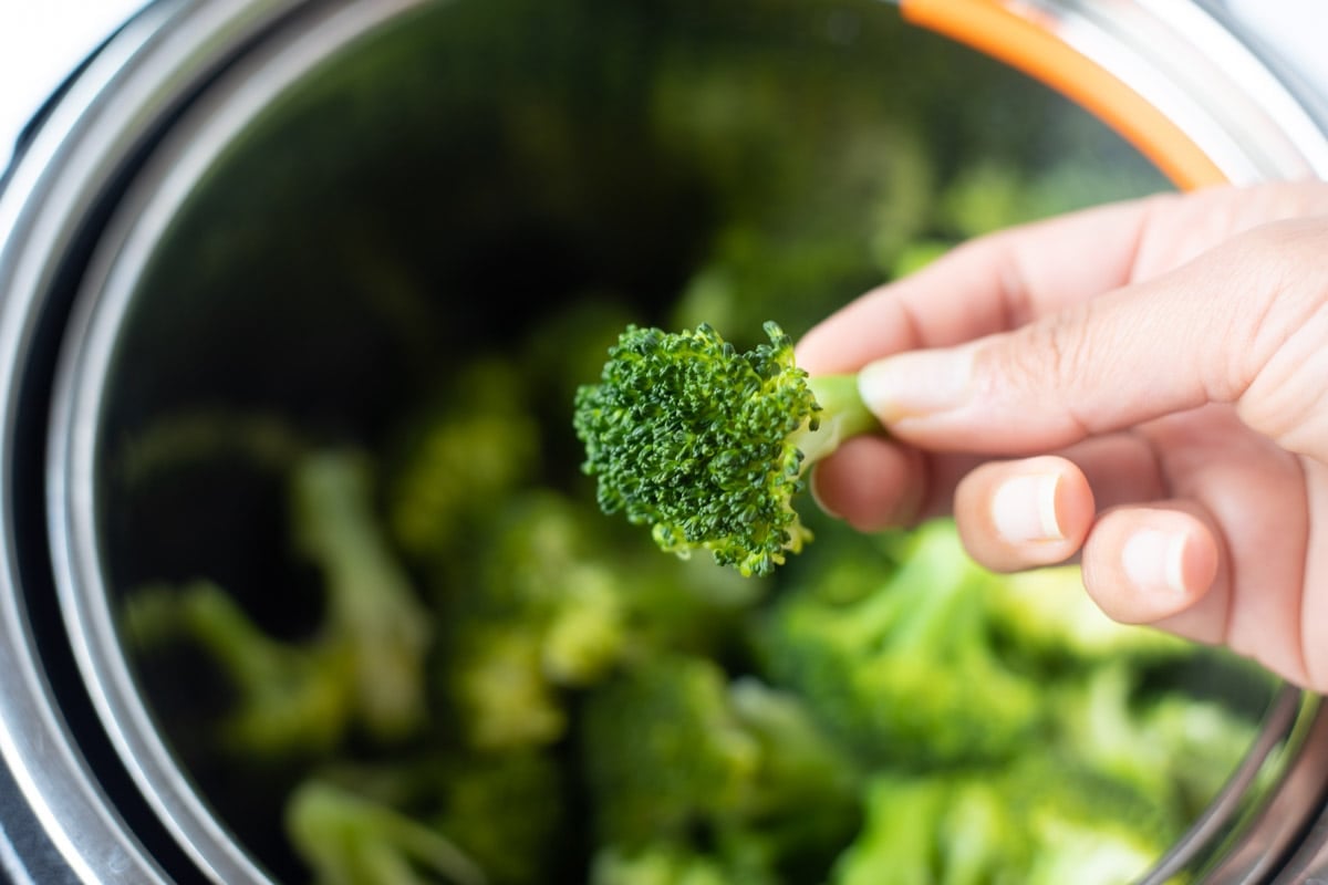 closeup of steamed broccoli in front of the instant pot