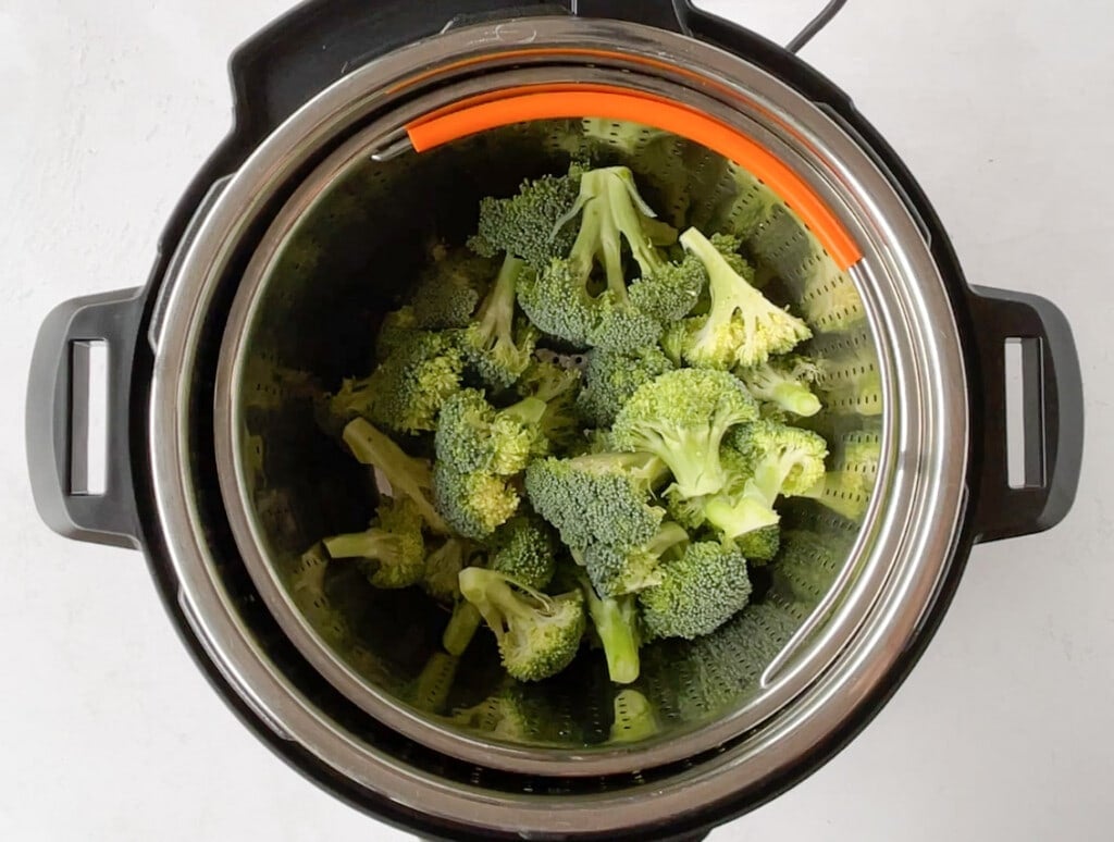 Broccoli in a steamer basket to be cooked in instant pot