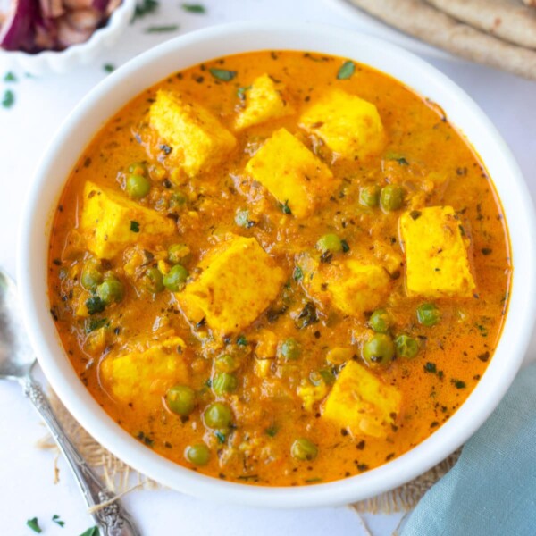 Matar Paneer (green peas and indian cottage cheese curry) served in a white bowl