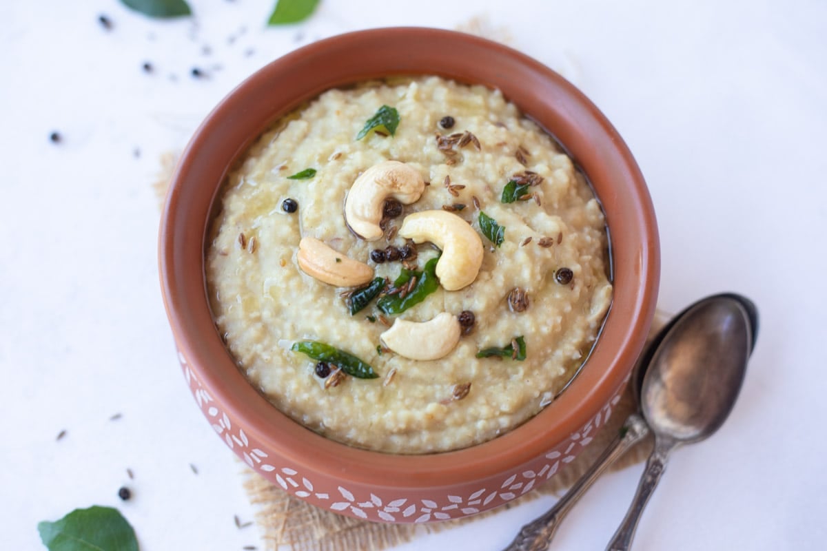 The BEST collection of 29 Instant Pot Indian Vegetarian Recipes from the best Indian food blogs! You can find a variety of vegetarian curries, lentils, beans and rice recipes from all over India. Millet Pongal served in a bowl