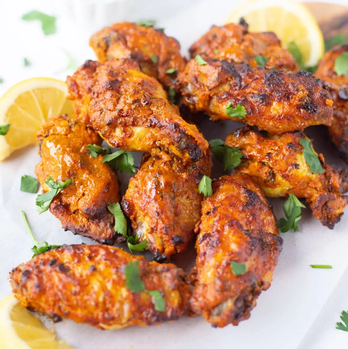 Tandoor chicken wings served with lime wedges