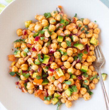 Indian style Chickpea salad in a bowl with veggies and spices