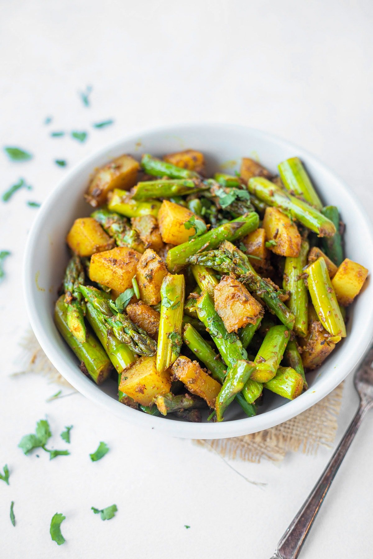 Easy indian asparagus stir fry with potatoes and spices in a bowl 