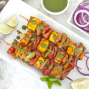 Panner tikka masala in skewers with mint chutney on the top