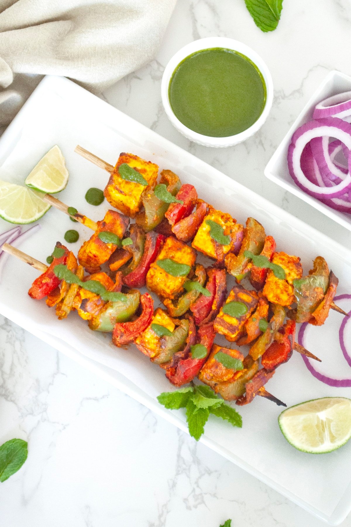 Panner tikka masala in skewers with mint chutney on the top