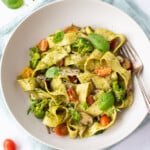 Pappardelle Noodle Pasta with pesto and vegetables in a bowl garnished with basil leaves