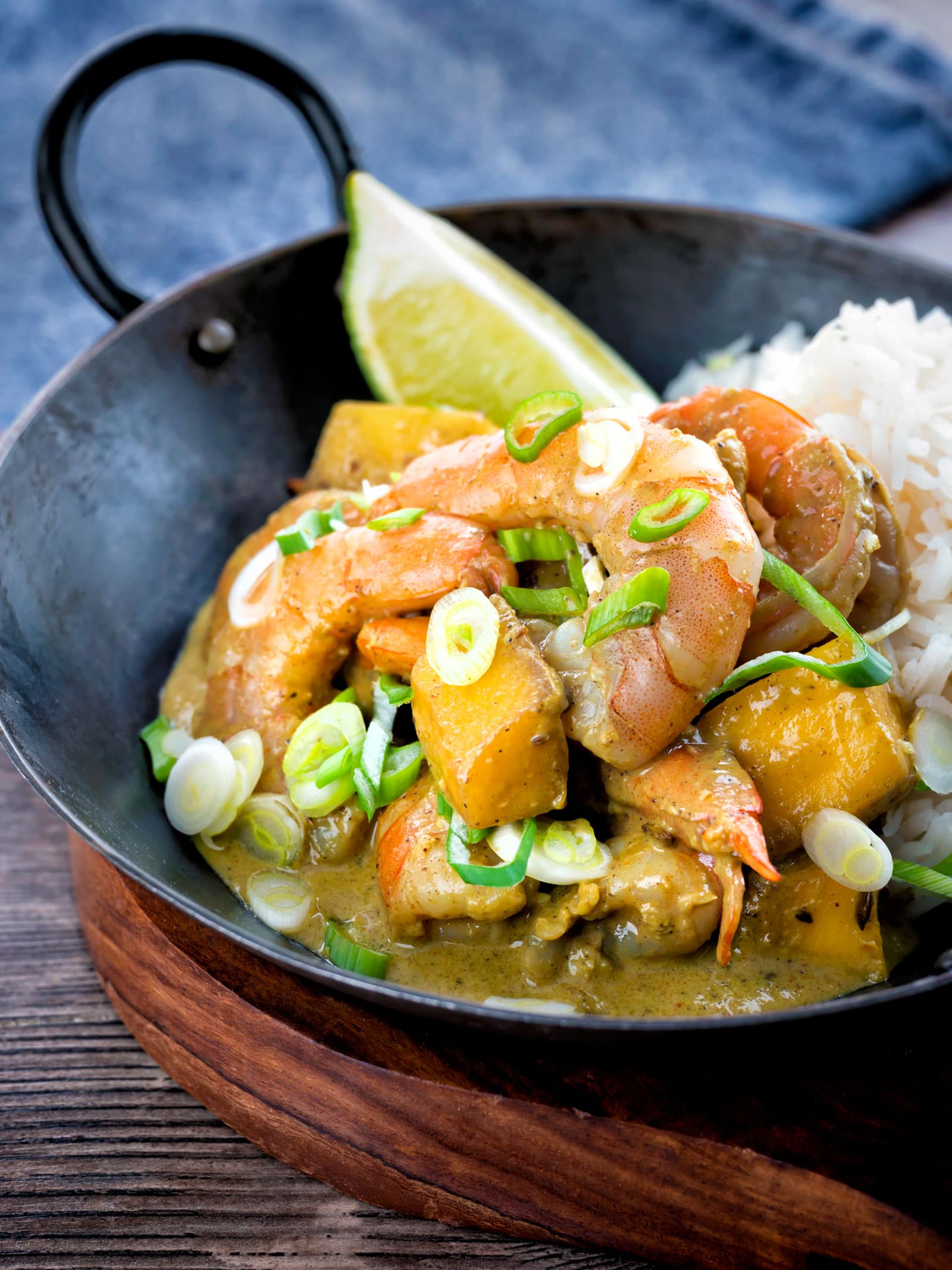 prawn and mango curry with rice in a pan